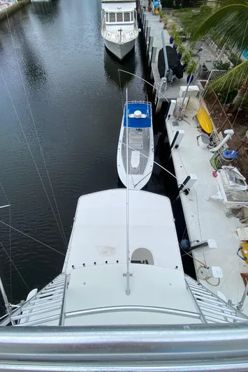 Mad East Yacht Photos Pics Aerial view of 1993 Hatteras Convertible yacht docked in a marina.