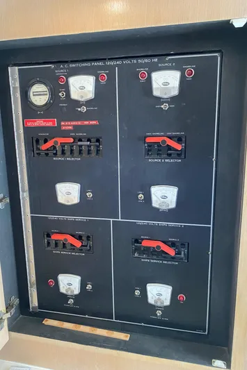 Mad East Yacht Photos Pics Electrical panel of a 1993 Hatteras Convertible boat with switches and meters.