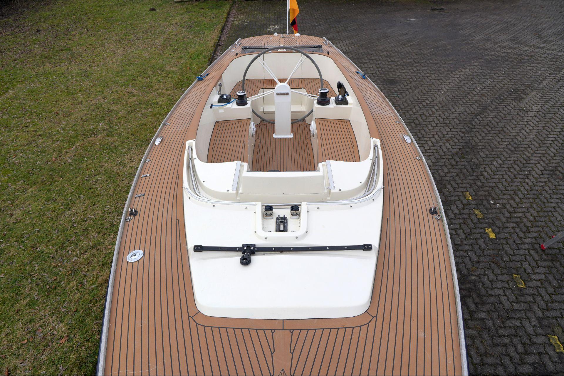 Top view of 2010 Saffier Se 26 sailboat with wooden deck and steering wheel.