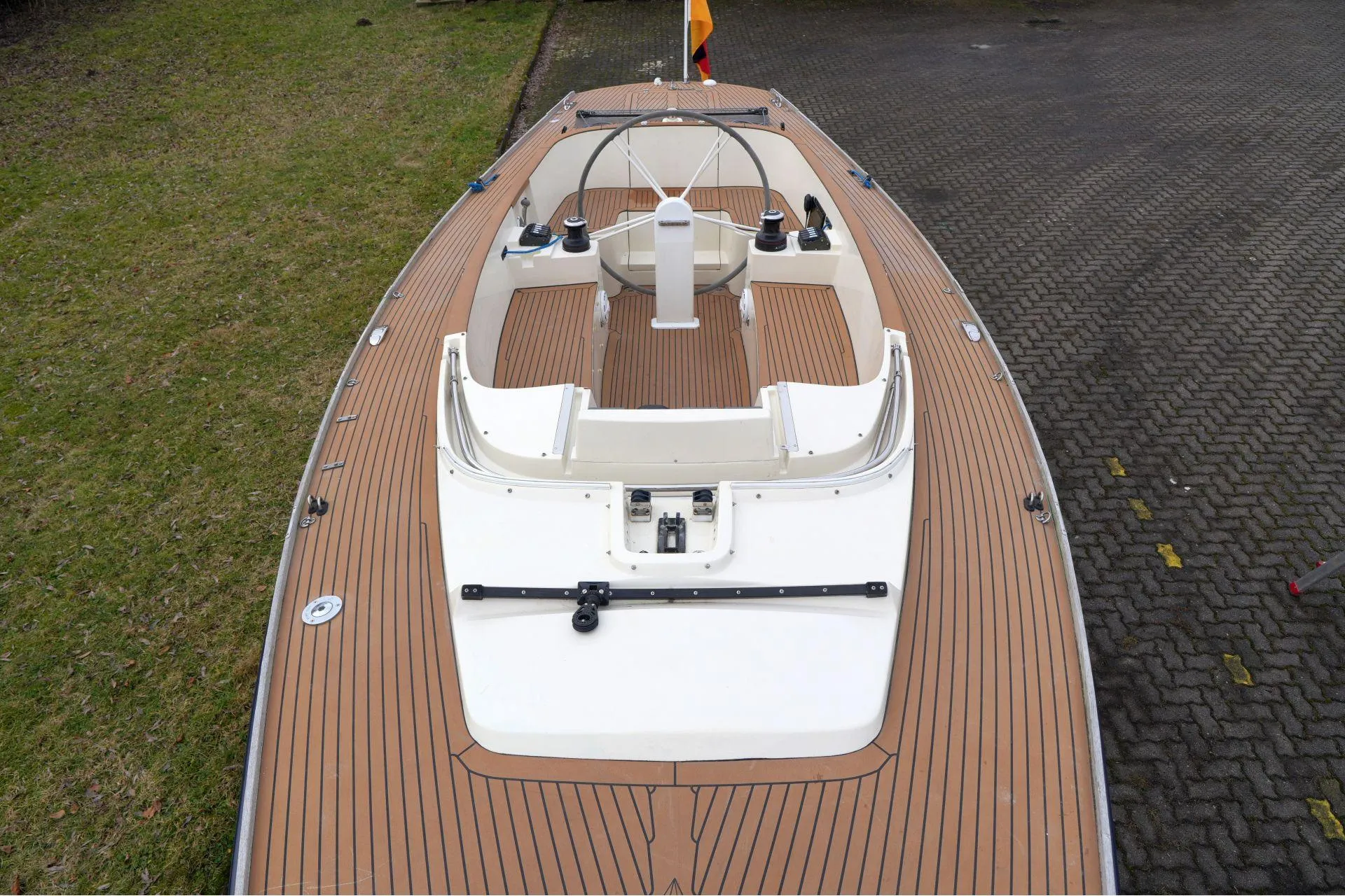 Top view of 2010 Saffier Se 26 sailboat with wooden deck and steering wheel.