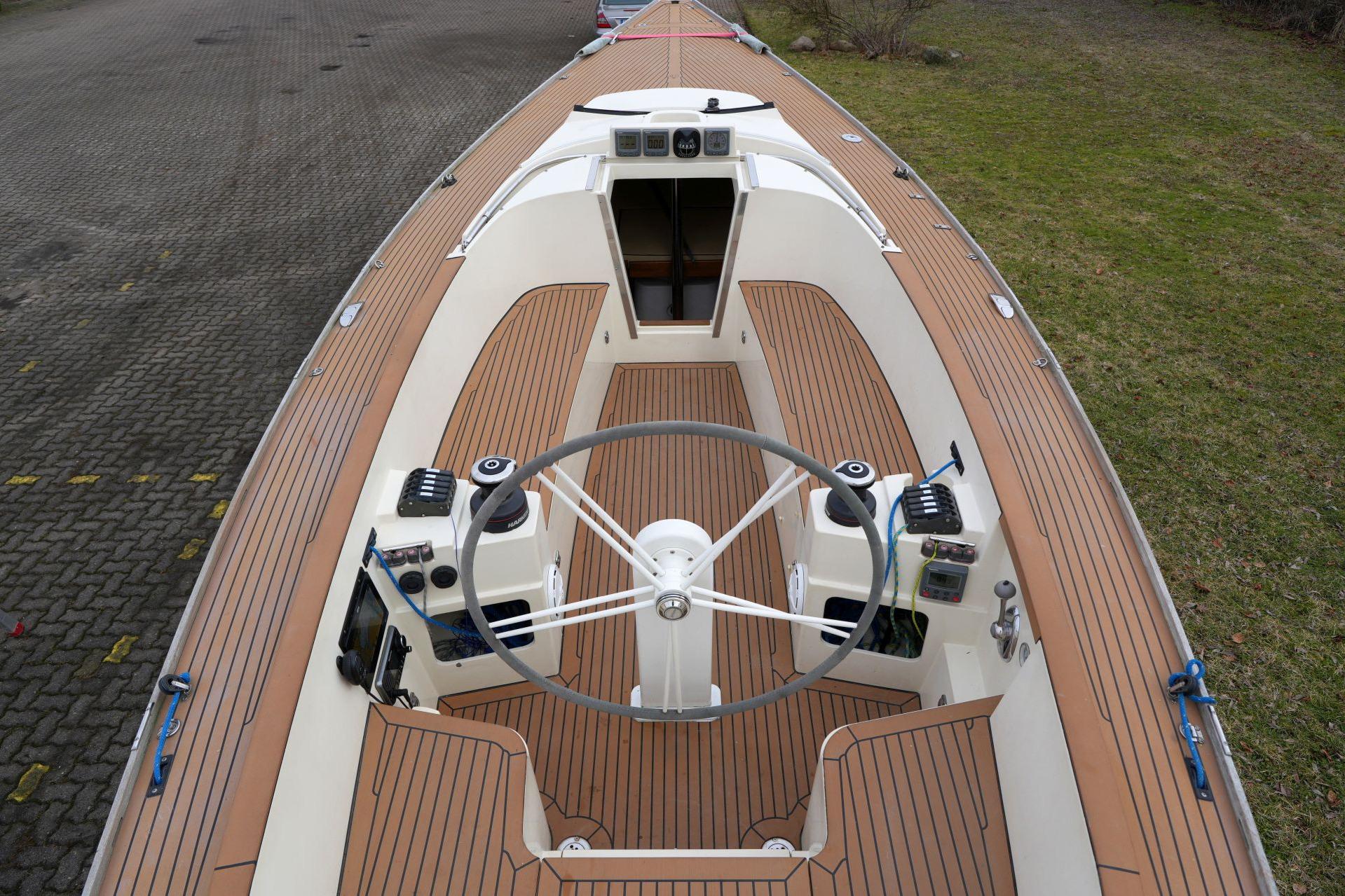 2010 Saffier Se 26 sailboat cockpit with wooden deck and steering wheel.