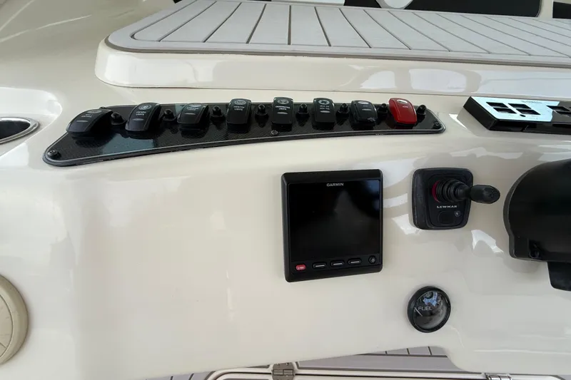 376-420 Brokerage Tyler Yacht Photos Pics Control panel of a 2020 Grady-White Canyon 376 boat with switches and Garmin display.