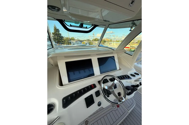 376-420 Brokerage Tyler Yacht Photos Pics 2020 Grady-White Canyon 376 boat helm with dual screens and steering wheel.