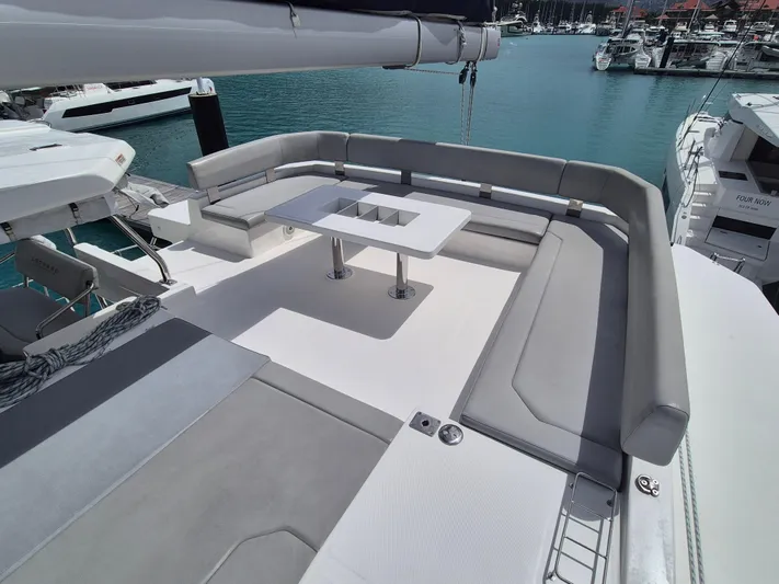 Takamaka Yacht Photos Pics Spacious seating area on a 2020 Leopard 50 yacht, featuring a modern table and marina view.