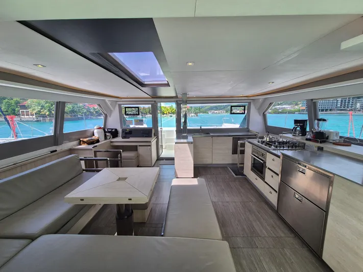 Takamaka Yacht Photos Pics Luxurious interior of a 2020 Leopard 50 yacht with modern kitchen and scenic ocean views.