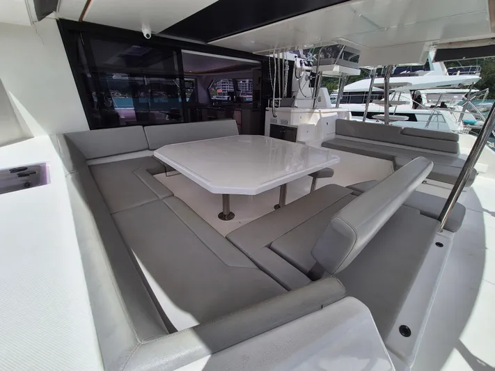 Takamaka Yacht Photos Pics Spacious seating area on a 2020 Leopard 50 yacht with a central table.