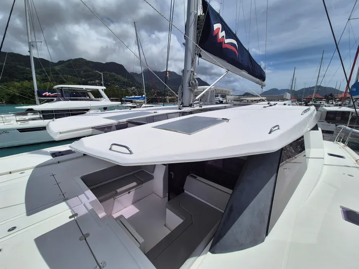 Takamaka Yacht Photos Pics Leopard 50 catamaran, 2020 model, docked with scenic mountain backdrop and clear skies.