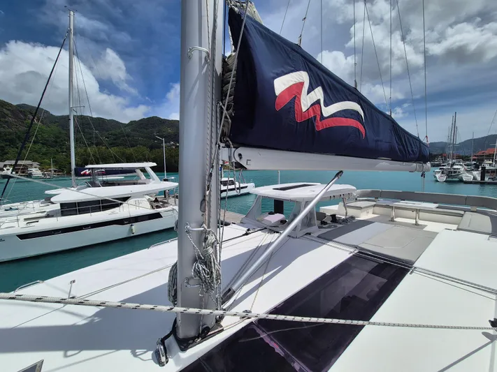 Takamaka Yacht Photos Pics 2020 Leopard 50 catamaran docked in a scenic marina with clear blue waters.