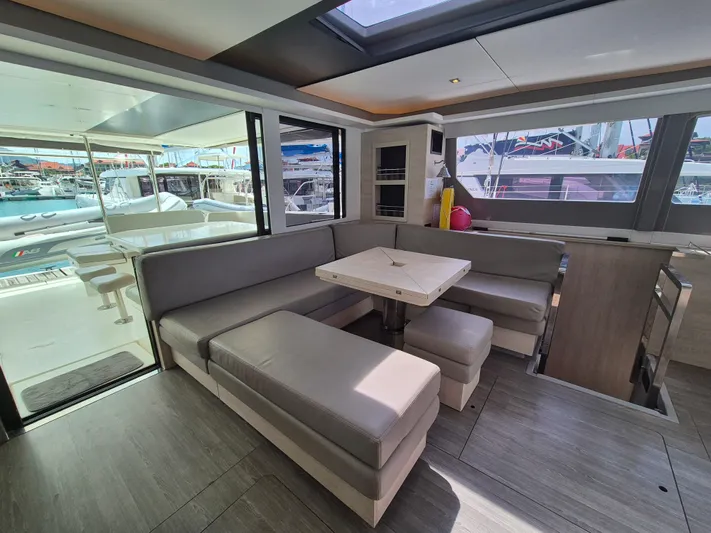 Takamaka Yacht Photos Pics Luxurious interior of a 2020 Leopard 50 yacht with modern seating and dining area.