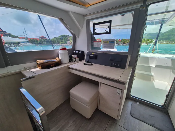 Takamaka Yacht Photos Pics Interior of 2020 Leopard 50 yacht with navigation station and scenic marina view.