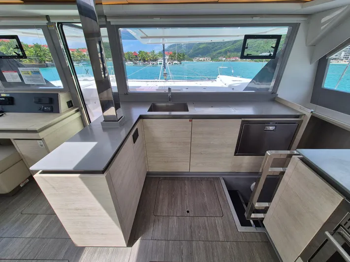 Takamaka Yacht Photos Pics Modern kitchen interior on a 2020 Leopard 50 yacht with ocean view.