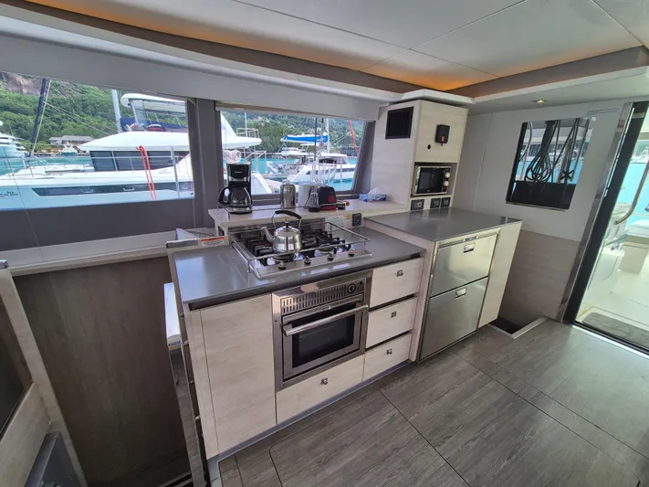 Takamaka Yacht Photos Pics Modern kitchen interior on a 2020 Leopard 50 yacht, featuring sleek appliances and ample counter space.