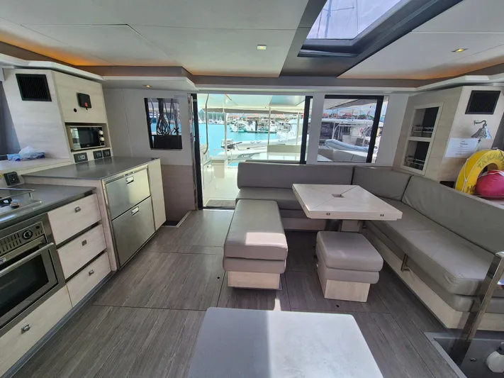 Takamaka Yacht Photos Pics Luxurious interior of a 2020 Leopard 50 yacht with modern kitchen and seating area.