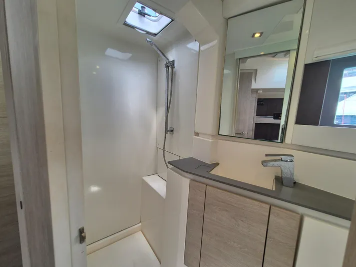 Takamaka Yacht Photos Pics Modern bathroom interior in a 2020 Leopard 50 yacht, featuring sleek fixtures and a shower.