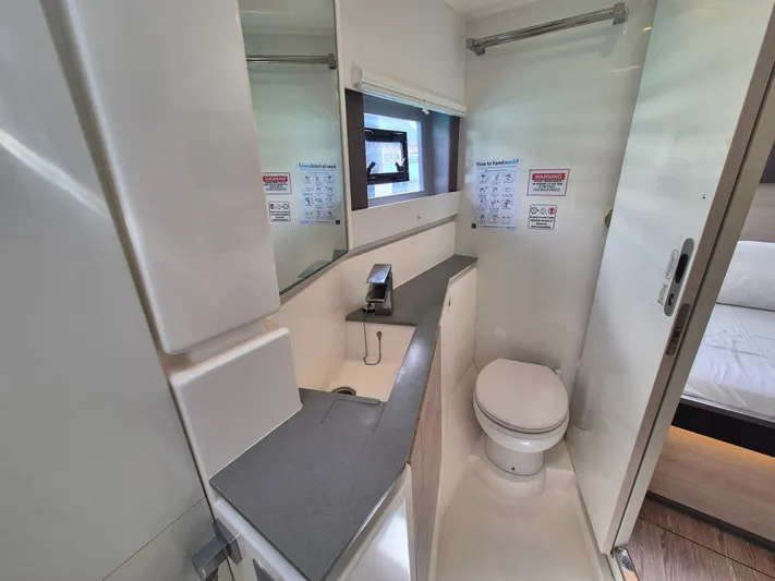 Takamaka Yacht Photos Pics Modern bathroom in a 2020 Leopard 50 yacht, featuring sleek design and compact functionality.