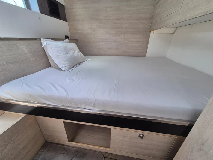 Takamaka Yacht Photos Pics Cozy bed in a 2020 Leopard 50 yacht cabin with modern wood finish.