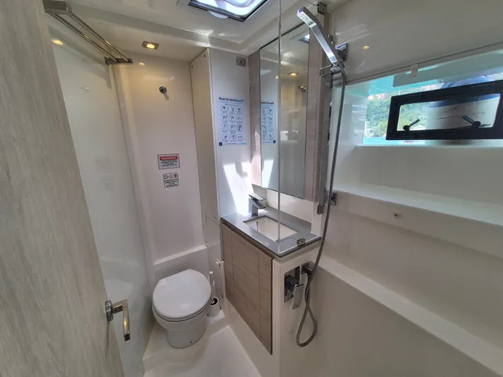Takamaka Yacht Photos Pics Modern bathroom in a 2020 Leopard 50 yacht, featuring sleek fixtures and natural lighting.