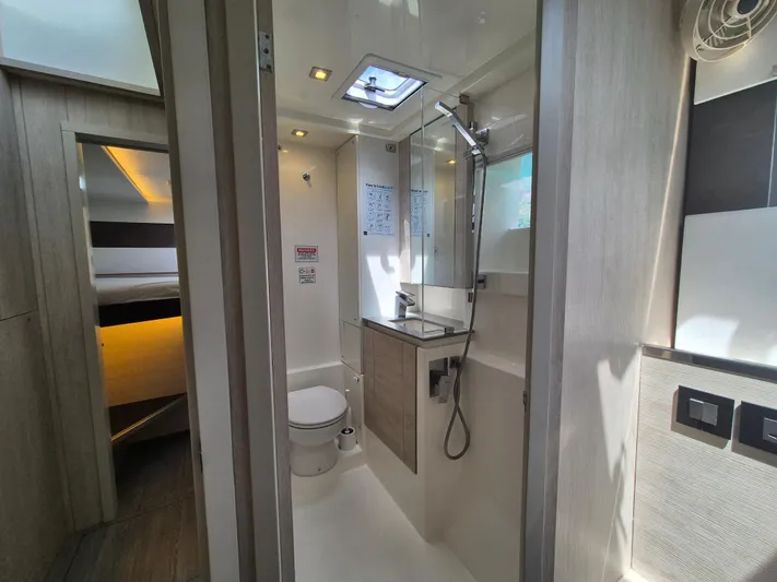 Takamaka Yacht Photos Pics Modern bathroom in a 2020 Leopard 50 yacht, featuring sleek design and natural lighting.