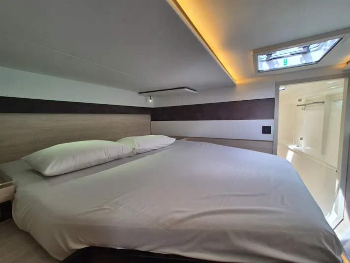 Takamaka Yacht Photos Pics Luxurious bedroom interior in a 2020 Leopard 50 yacht, featuring a spacious bed and modern design.