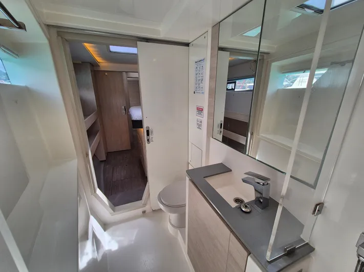 Takamaka Yacht Photos Pics Modern bathroom interior on a 2020 Leopard 50 yacht, featuring sleek design and amenities.