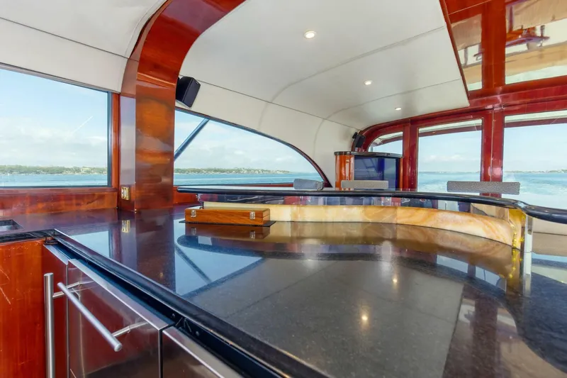 Patron Yacht Photos Pics Luxurious interior of 2004 Custom Ebony Sportfish 65' CNV yacht with sleek design and ocean view.