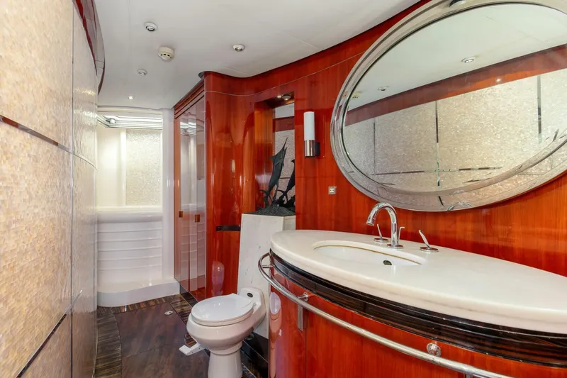 Patron Yacht Photos Pics Luxurious bathroom in 2004 Custom Ebony Sportfish 65' CNV yacht with elegant wood finishes.