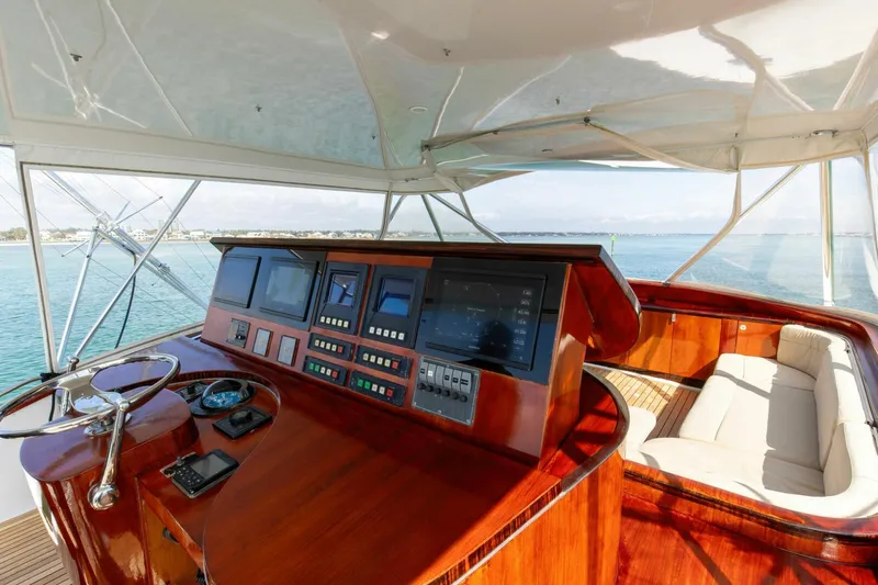 Patron Yacht Photos Pics Luxurious helm of 2004 Custom Ebony Sportfish 65' CNV yacht with polished wood finish.