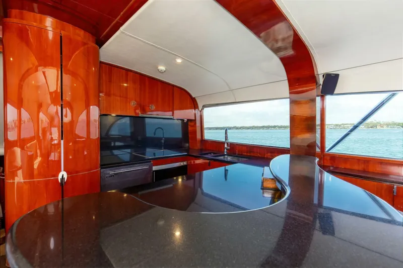 Patron Yacht Photos Pics Luxurious interior of 2004 Custom Ebony Sportfish 65' CNV yacht with sleek wood finishes.