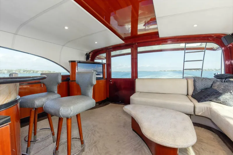 Patron Yacht Photos Pics Luxurious interior of 2004 Custom Ebony Sportfish 65' CNV yacht with elegant seating and ocean view.