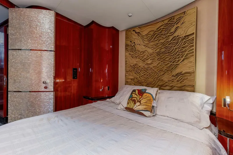 Patron Yacht Photos Pics Luxurious bedroom interior of 2004 Custom Ebony Sportfish 65' CNV yacht with elegant wood paneling.