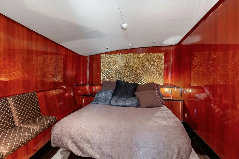 Patron Yacht Photos Pics Luxurious bedroom interior of 2004 Custom Ebony Sportfish 65' CNV yacht with elegant wood paneling.