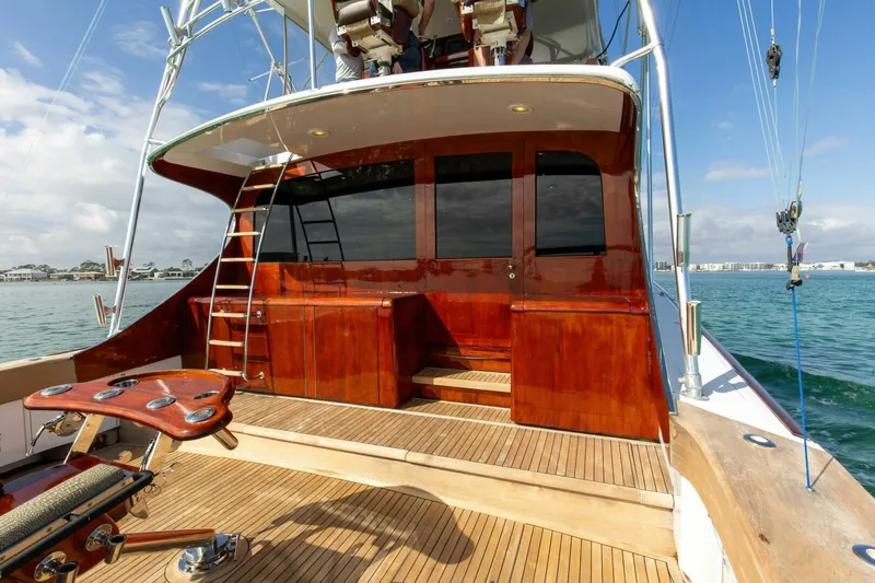 Patron Yacht Photos Pics Custom Ebony Sportfish 65' CNV yacht, 2004 model, with polished wood deck and ladder.