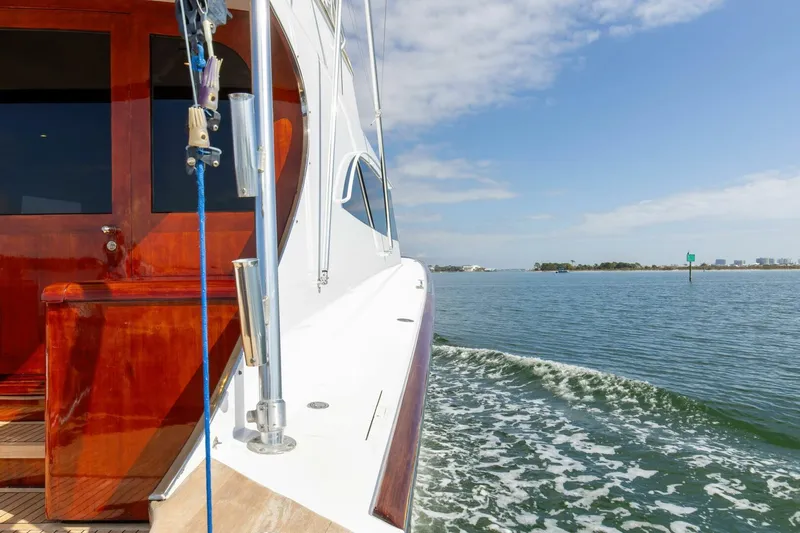 Patron Yacht Photos Pics Custom Ebony Sportfish 65' CNV yacht cruising on open water, 2004 model.