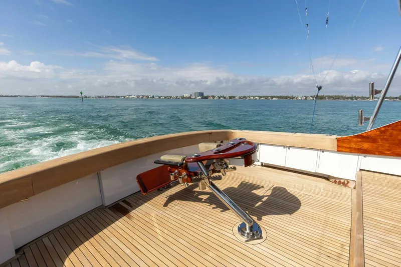 Patron Yacht Photos Pics Custom Ebony Sportfish 65' CNV 2004 yacht deck with ocean view and fishing chair.
