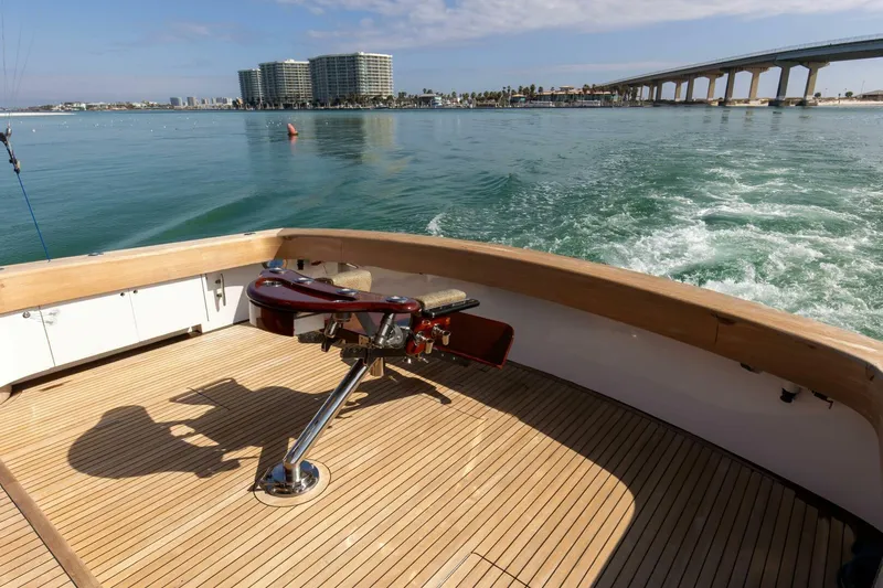 Patron Yacht Photos Pics Custom Ebony Sportfish 65' CNV 2004 yacht deck with ocean view and cityscape background.