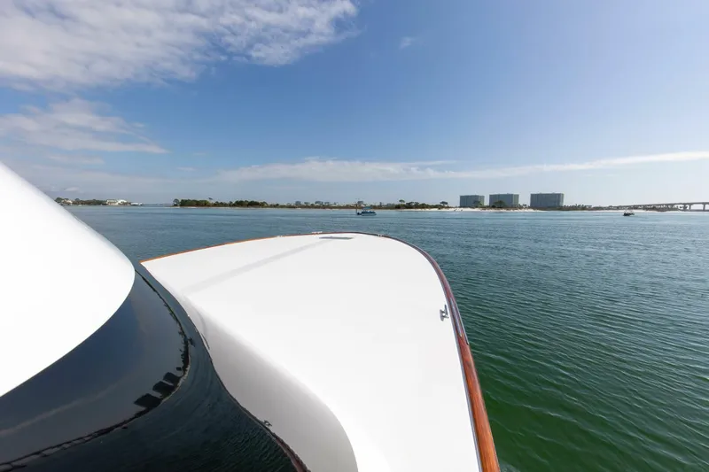 Patron Yacht Photos Pics Custom Ebony Sportfish 65' CNV yacht on calm waters, 2004 model, scenic view.