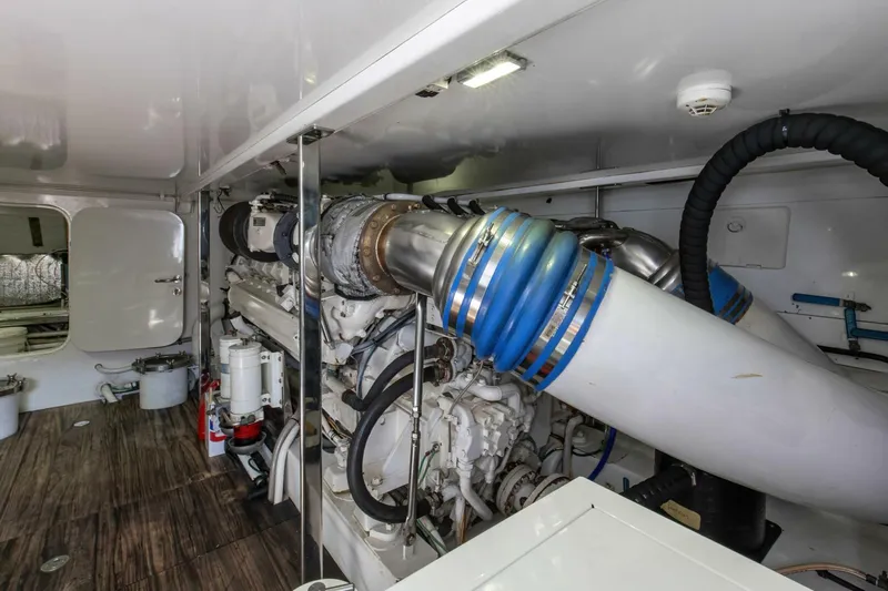 Patron Yacht Photos Pics Engine room of 2004 Custom Ebony Sportfish 65 Convertible with visible machinery and components.