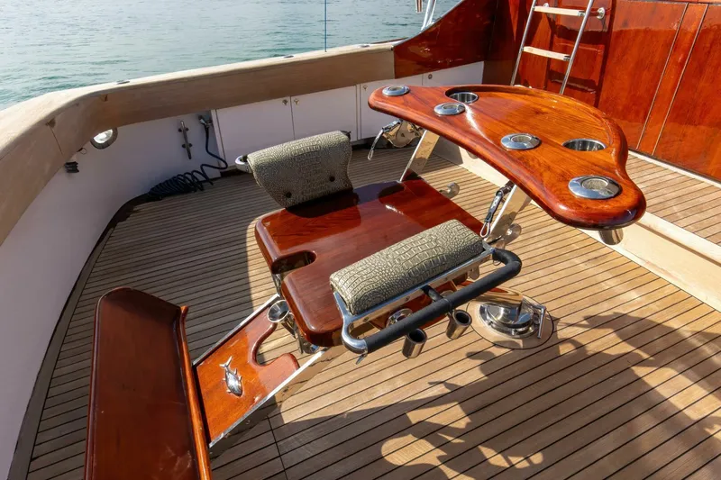 Patron Yacht Photos Pics Luxurious 2004 Custom Ebony Sportfish 65' CNV yacht deck with polished wood seating.