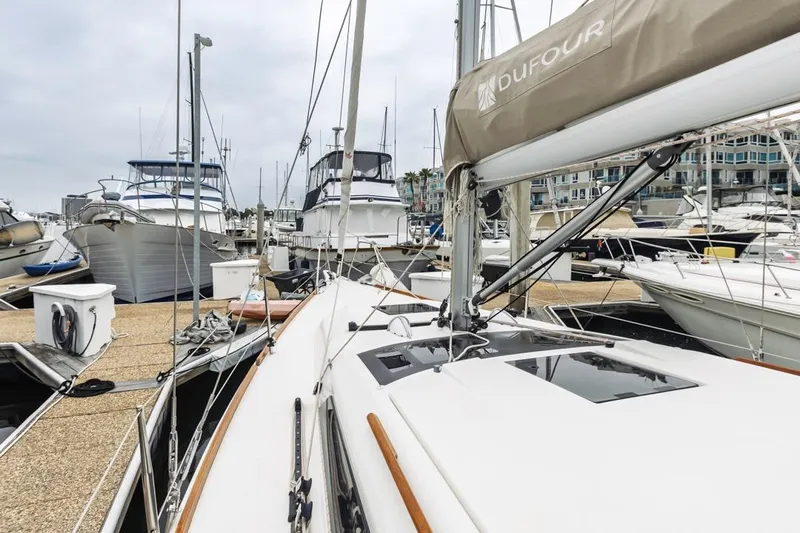 Dotwick Jinga Yacht Photos Pics Dufour 360 sailboat, 2020 model, docked in a marina with other boats.