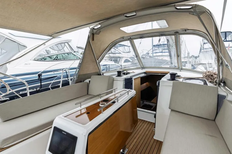 Dotwick Jinga Yacht Photos Pics Interior view of 2020 Dufour 360 sailboat with seating and navigation equipment.