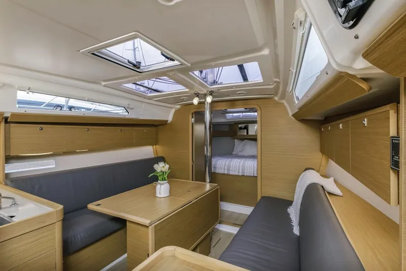 Dotwick Jinga Yacht Photos Pics Modern interior of 2020 Dufour 360 sailboat with wood finish and skylights.