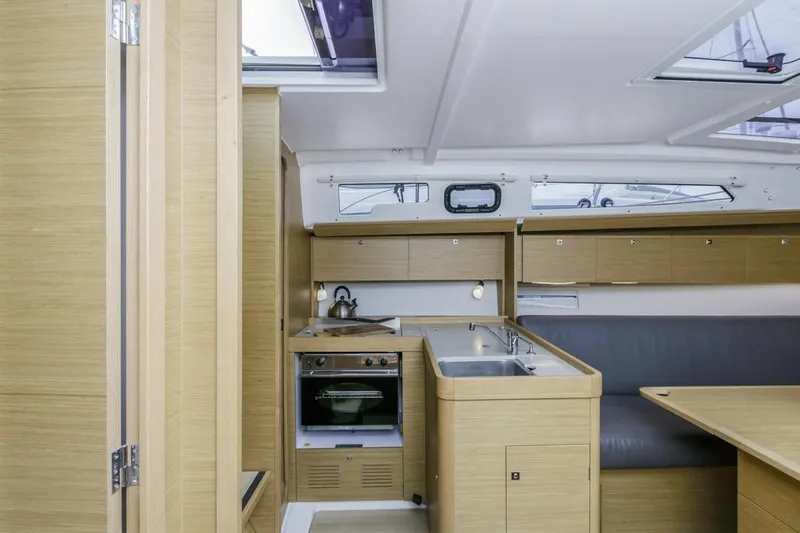 Dotwick Jinga Yacht Photos Pics Interior of 2020 Dufour 360 yacht, featuring modern kitchen and seating area.