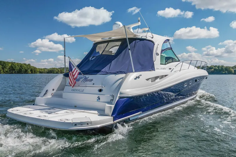 Night Moves Yacht Photos Pics 2005 Sea Ray 500 Sundancer yacht cruising on a sunny day with American flag.