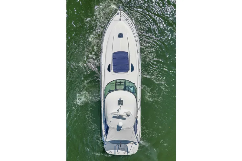 Night Moves Yacht Photos Pics Top view of a 2005 Sea Ray 500 Sundancer yacht cruising on green water.