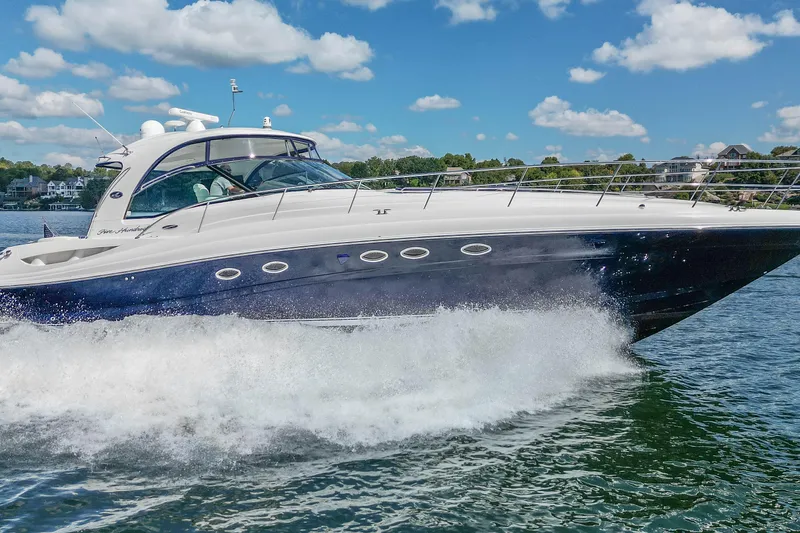 Night Moves Yacht Photos Pics 2005 Sea Ray 500 Sundancer yacht cruising on a sunny day with blue skies.