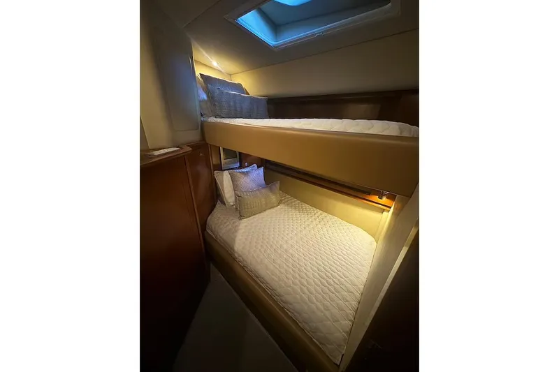 Night Moves Yacht Photos Pics 2005 Sea Ray 500 Sundancer cabin with cozy bunk beds and soft lighting.
