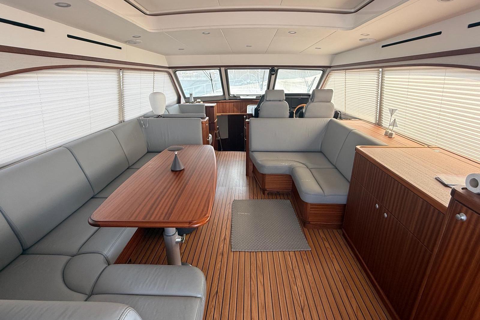 Luxurious interior of 2023 Elling E6 yacht with elegant wood and leather furnishings.