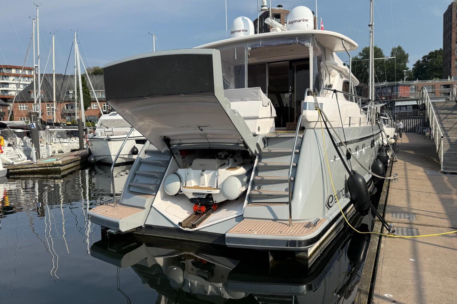 2023 Elling E6 yacht docked at marina, showcasing open rear deck and luxurious design.