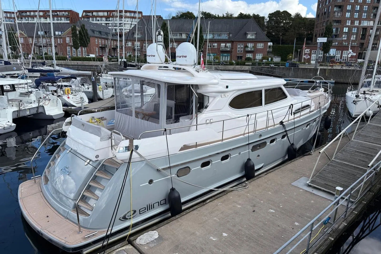 2023 Elling E6 yacht docked at a marina, surrounded by other boats.