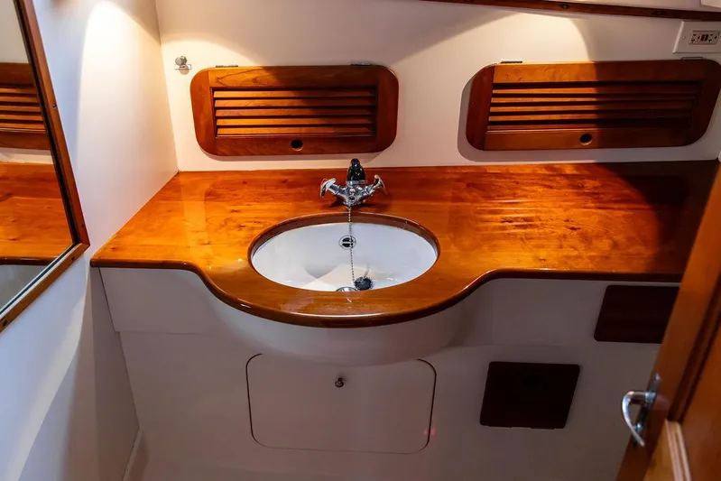 Belle Yacht Photos Pics Hinckley 1998 Picnic Boat interior with wooden countertop and sink.